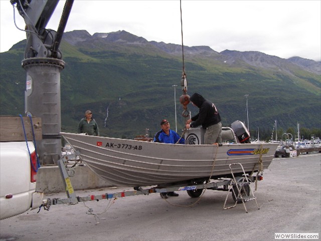 Setting up sling to lift boat and trailer with Crane in  Valdez AK